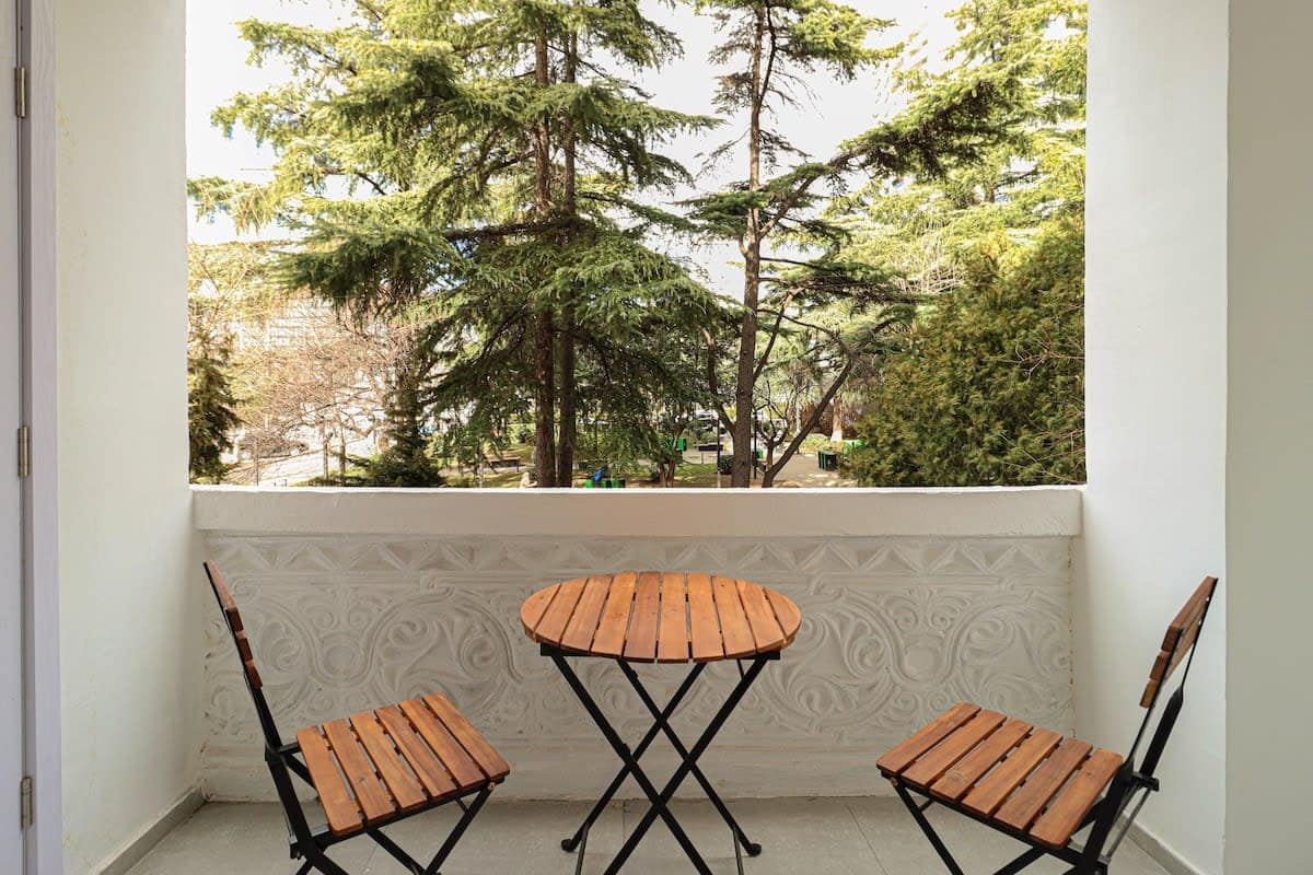 Cozy seating area with a chair and table makes it easy to enjoy meals or a quiet moment outdoors