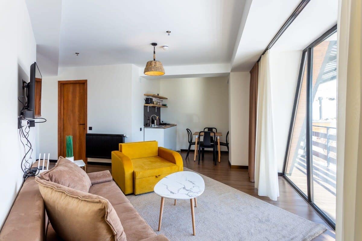 The white walls blend with colorful furniture, creating and inviting atmosphere.
