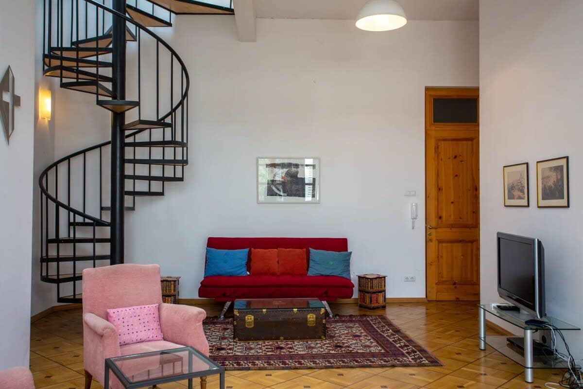 The spiral staircase leads up to the bedroom.