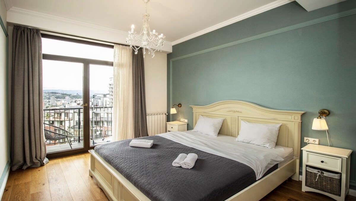 Relax in this elegant master bedroom with a king-size bed.