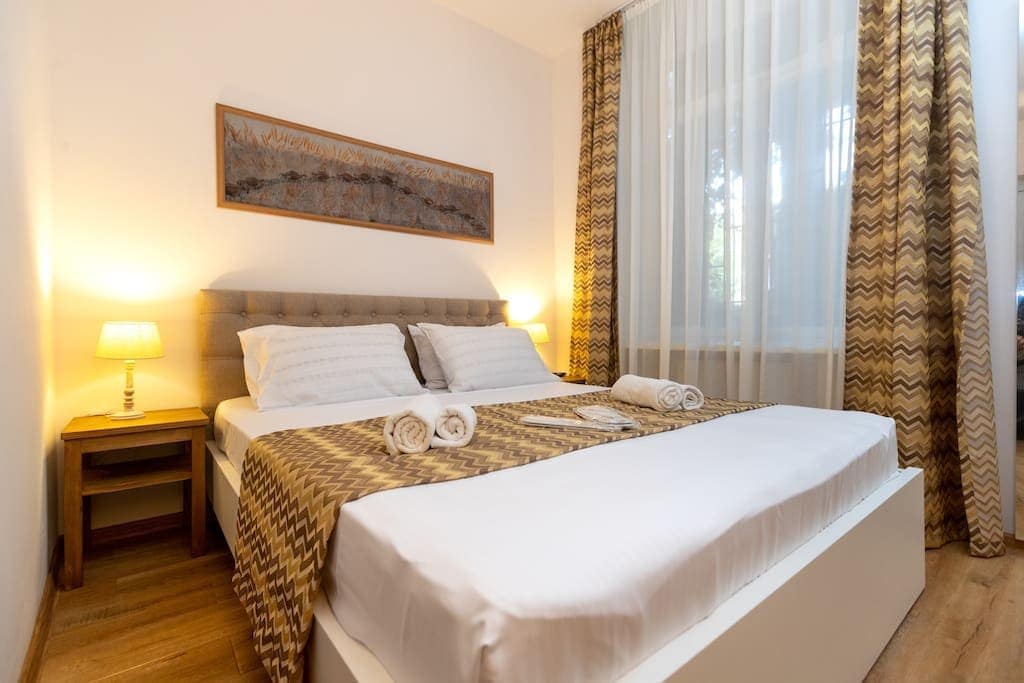 Bright and airy bedroom features two comfortable single beds