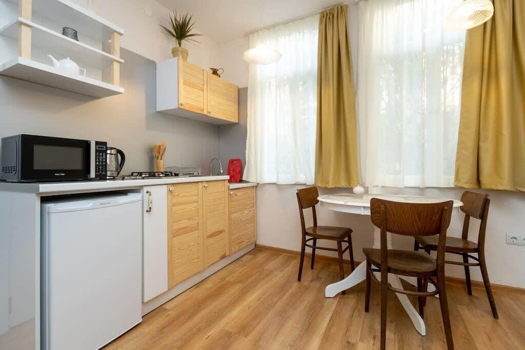 Open kitchen is seamlessly integrated into the space, providing a modern and fully equipped area for cooking and dining