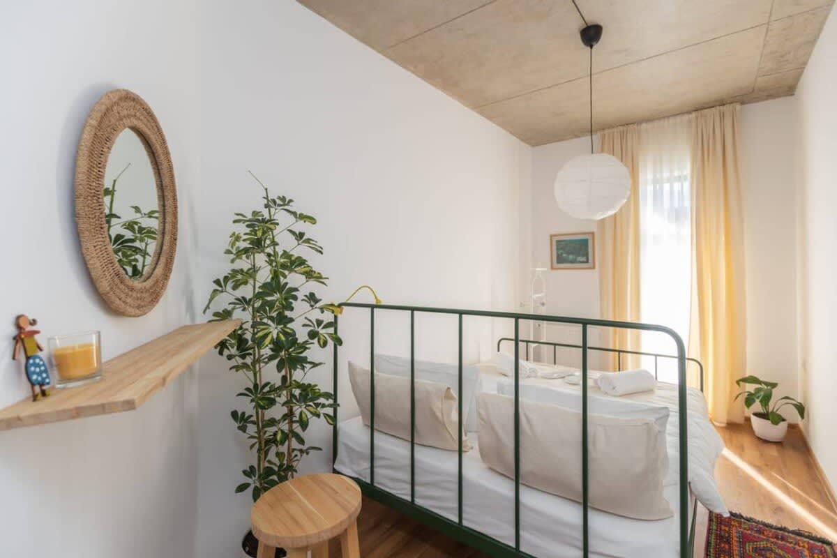 Step into a bright and airy bedroom, where soothing green tones create a calm and inviting atmosphere