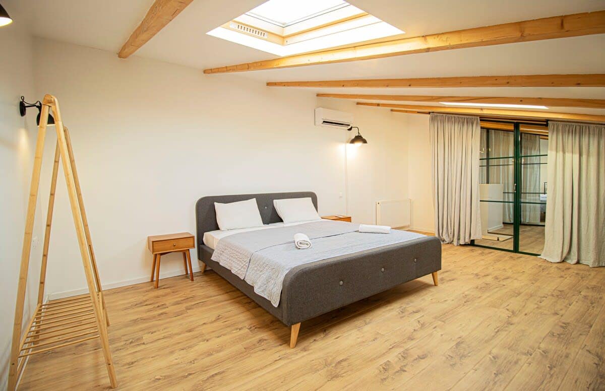 The large ceiling window floods the room with natural light, creating a bright and relaxing ambiance.