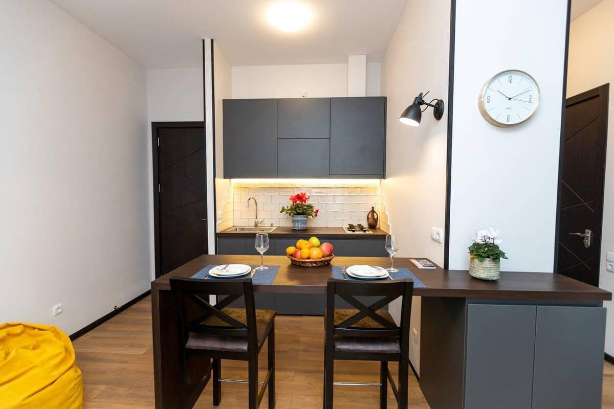 Open kitchen is fully equipped with modern appliances, sleek cabinetry, and all the essentials needed for home-cooked meals