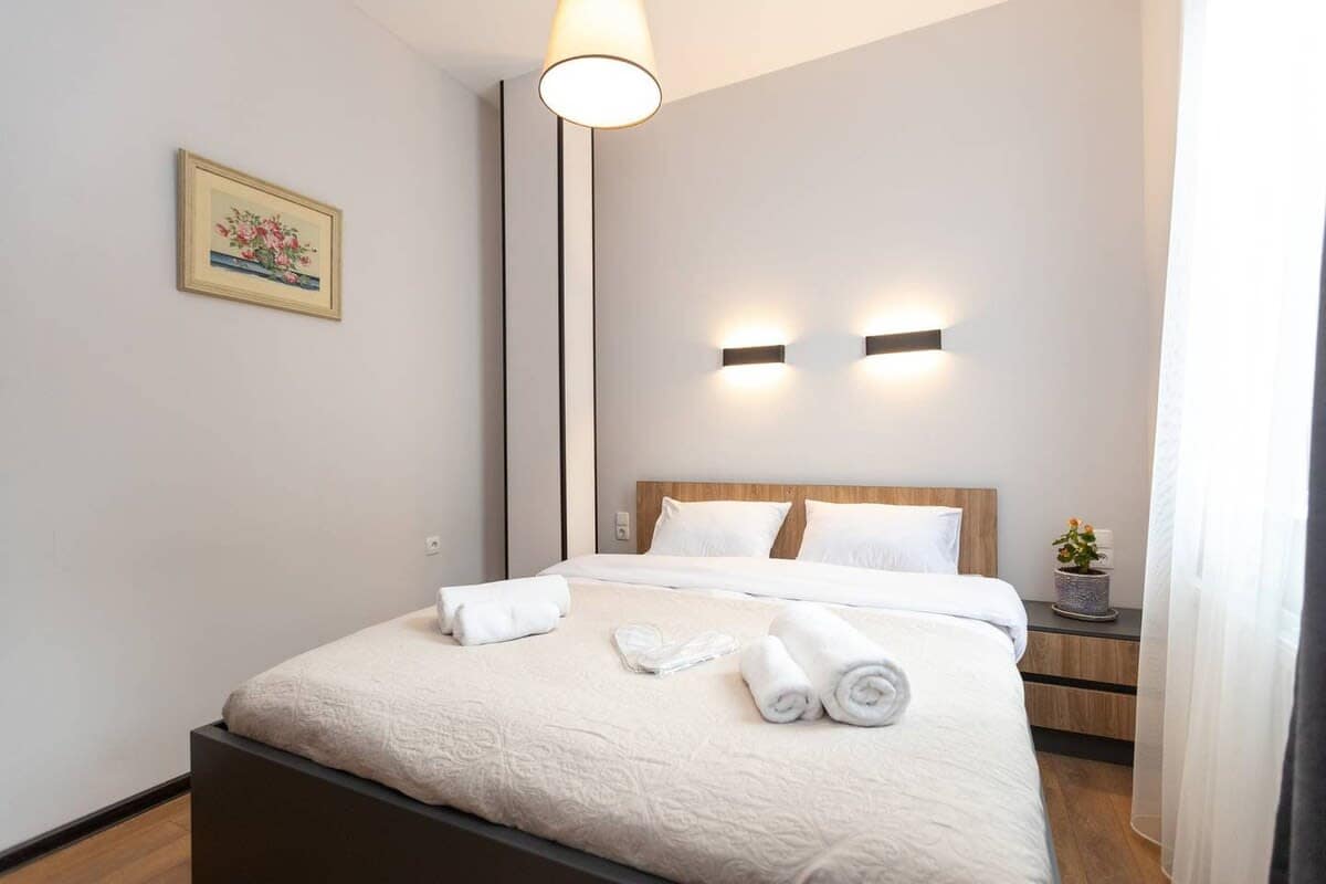 Bed is dressed in crisp, fresh linens for a clean and cozy sleep experience