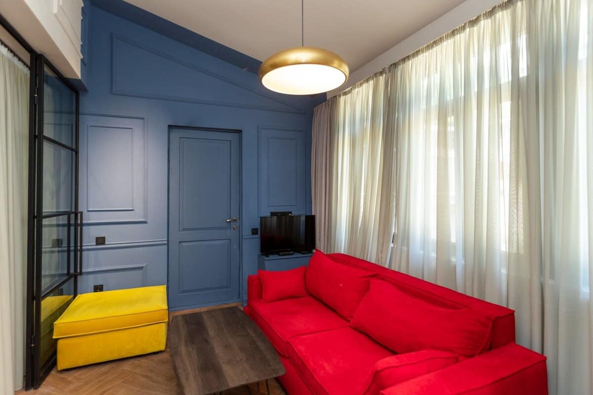 Bright and inviting, the living room features vibrant sofas