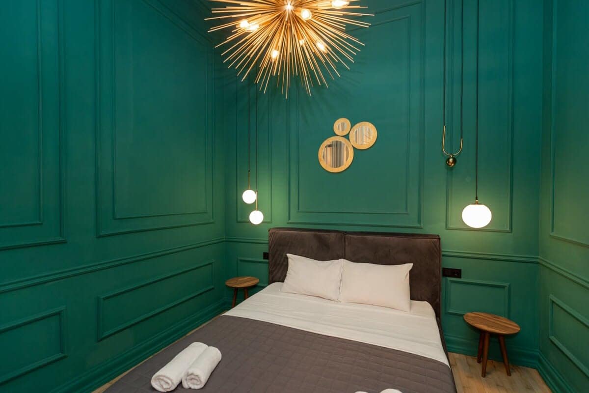 Warm bedside lighting and refreshing green accents