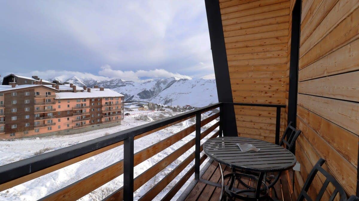 Step onto the balcony, complete with a small coffee table and two chairs, ideal for soaking in the fresh air and scenic views.