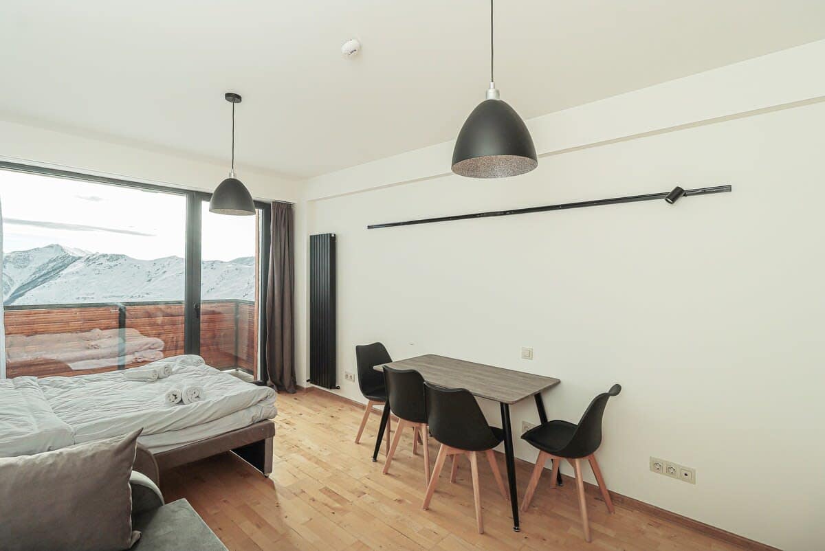 Bask in the natural light streaming through large windows that illuminate the entire apartment, creating a warm and airy atmosphere perfect for relaxation and comfort.