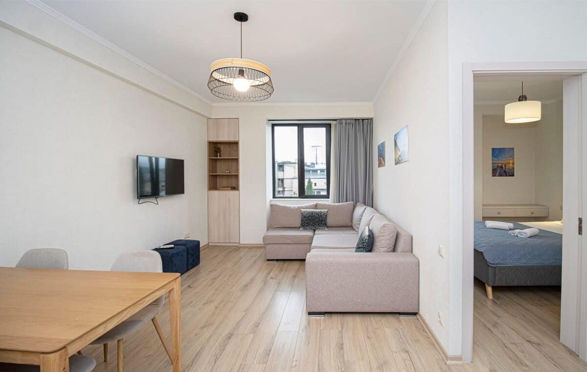 Well-lit living room with large windows that bring in plenty of natural light.