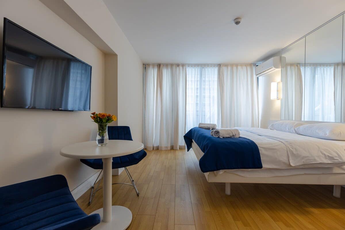 Flat-screen TV provides entertainment, while air conditioning ensures a pleasant atmosphere at all times