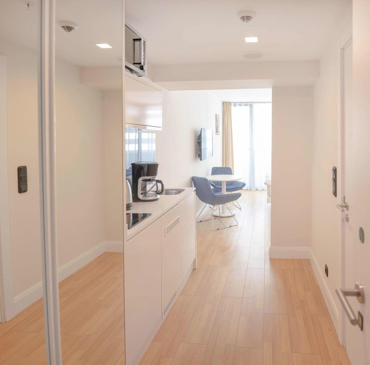 Hall with a functional wardrobe and a mirror