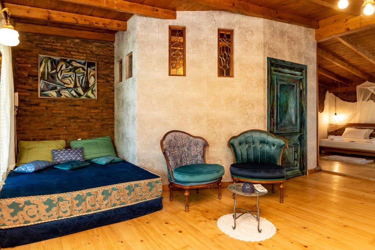 Plush Daybed for Lounging – A large, vibrant daybed with patterned upholstery offers the perfect spot for reading or napping.