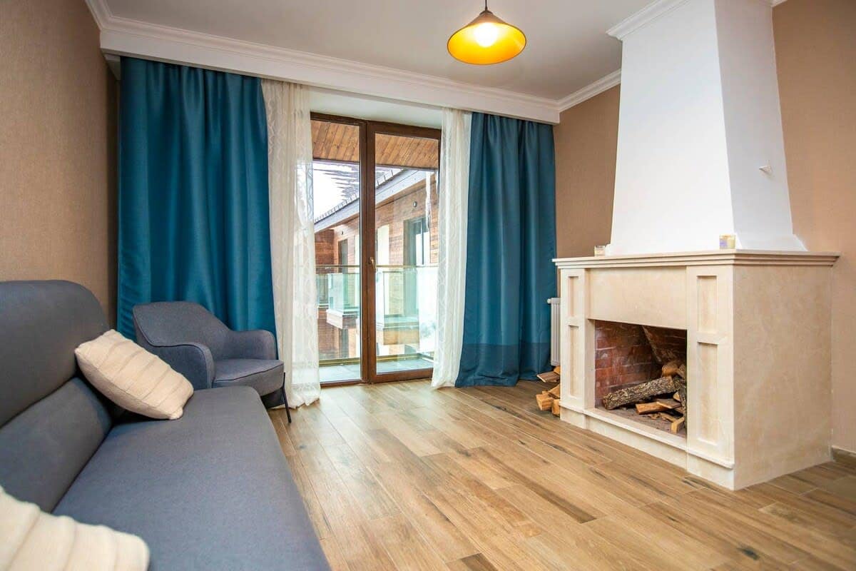 A warm and inviting living space featuring a fireplace, flat-screen TV, and a dining area, perfect for shared moments with family or friends.
