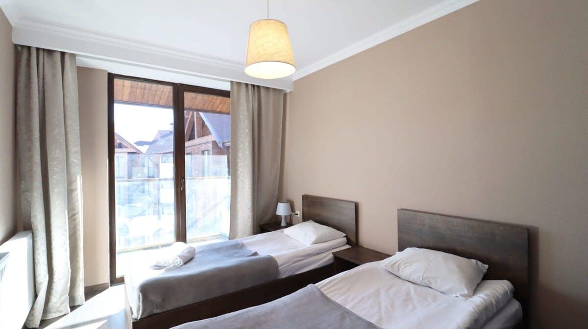 Spacious and cozy bedrooms with fresh linens and a total of 4 single beds, offering a restful retreat for up to 5 adults.