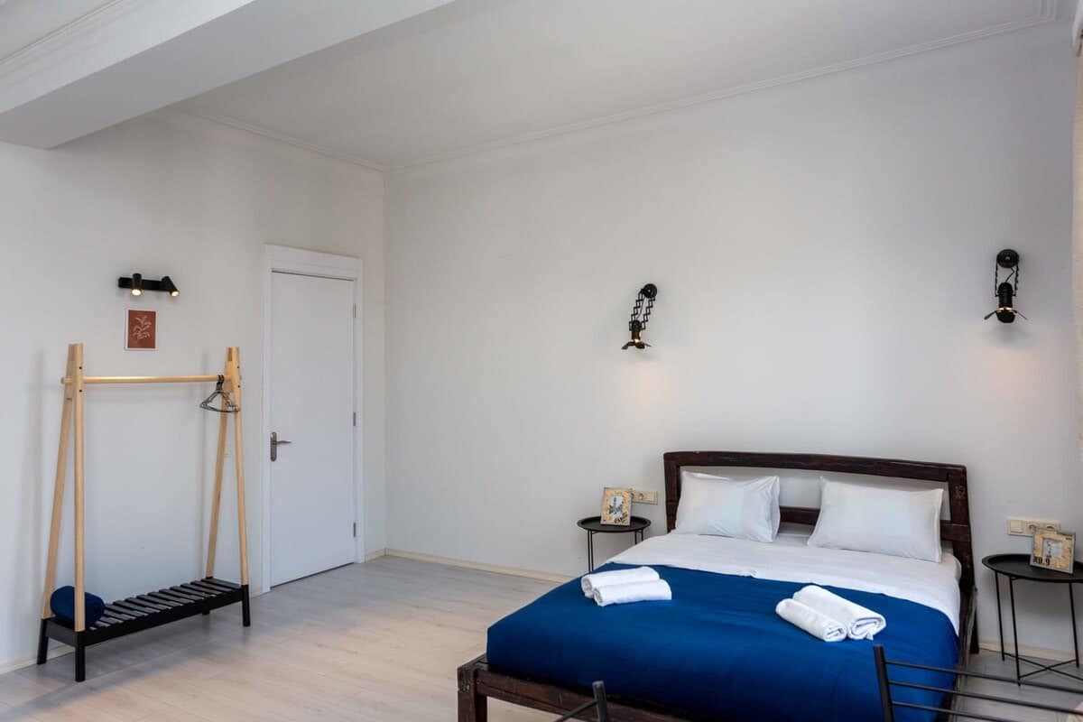 Comfortable double bed is dressed in fresh linens, ensuring a restful night’s sleep