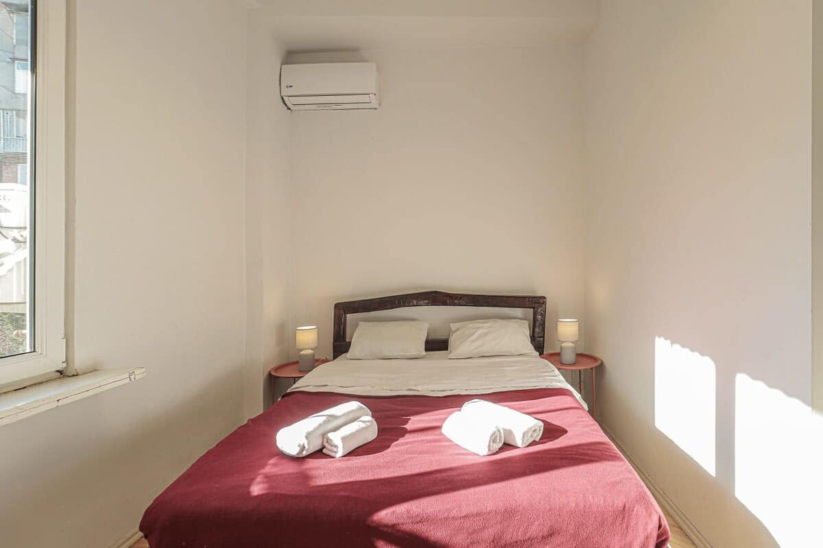 Spacious and well-lit bedroom offers a cozy retreat with plenty of natural light streaming in