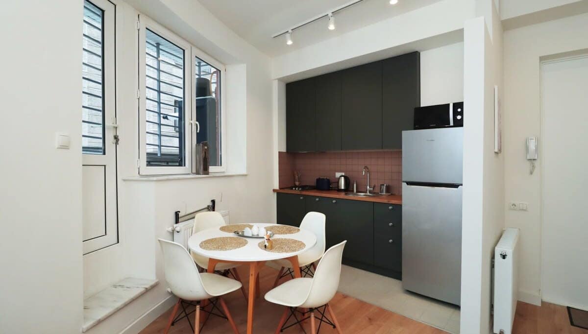 Open kitchen is fully equipped with all the essentials, including modern appliances and cookware