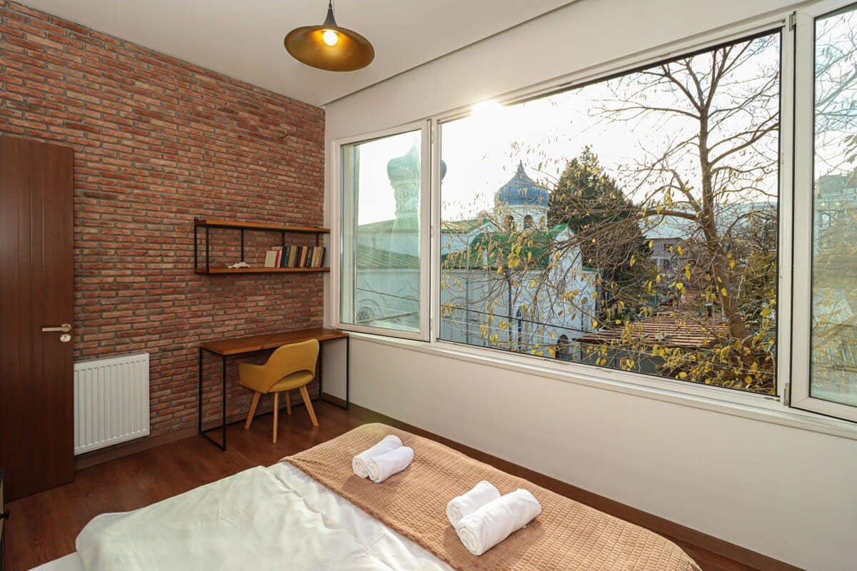 Large windows fill the space with natural light, creating a bright and airy atmosphere throughout the day