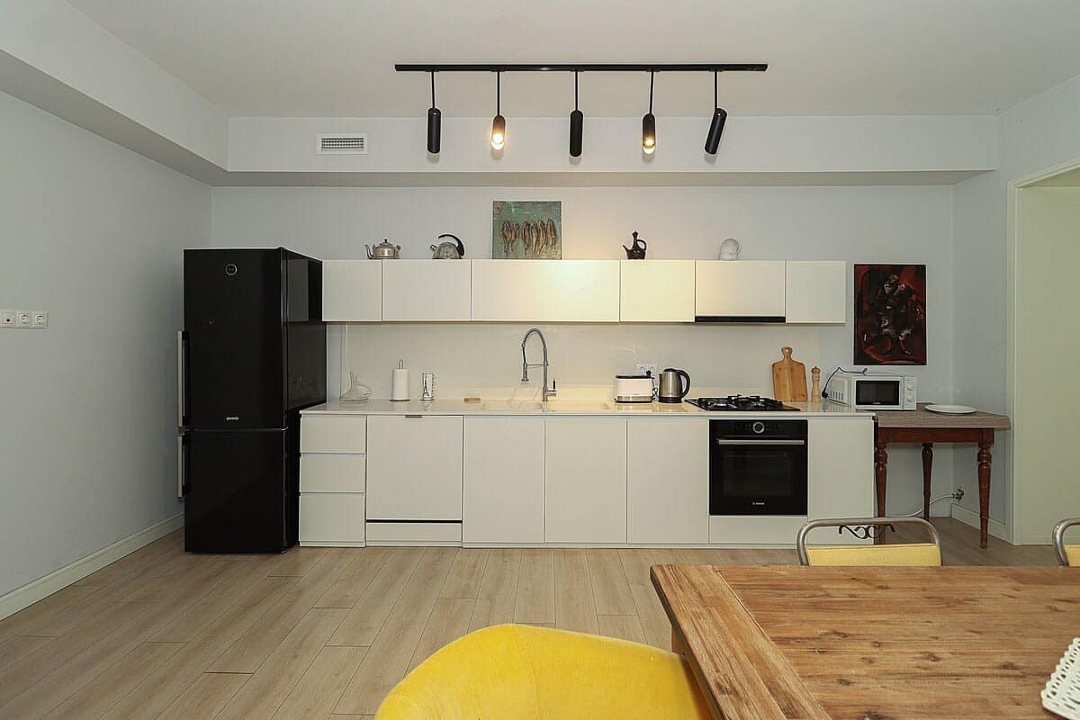 Open-concept living room featuring a large, fully equipped kitchen.