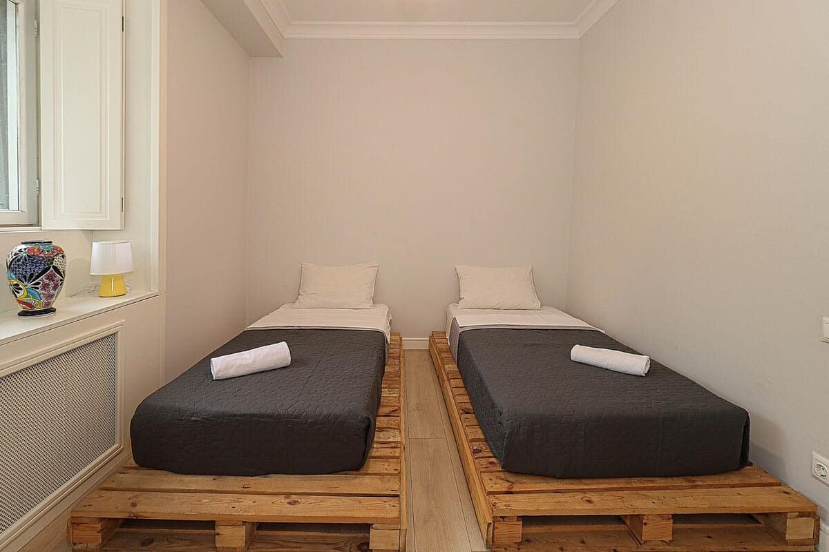 Two single beds placed next to each other in another bedroom.