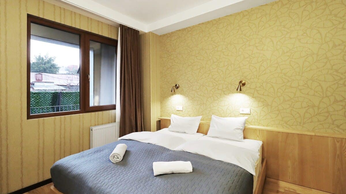 The sleeping area is spacious and features two single beds that can be combined for a comfortable night's rest.