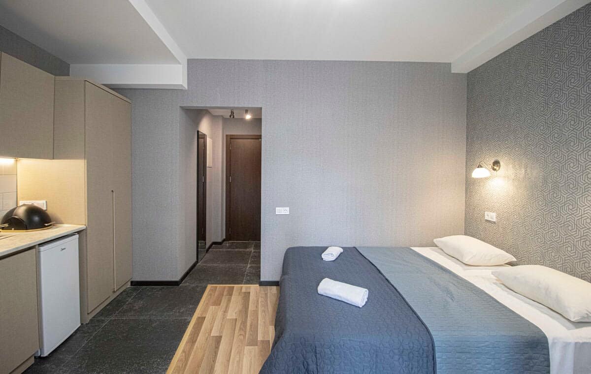 Professionally cleaned and neatly arranged, the bed offers a hotel-like experience in the comfort of a studio setting